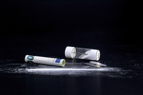 Cocaine Line and Razor Blade on a Black Background