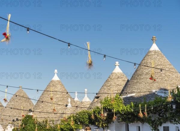 Sunshine on summer vacation in trulli town of Alberobello in Puglia, Italy, Europe