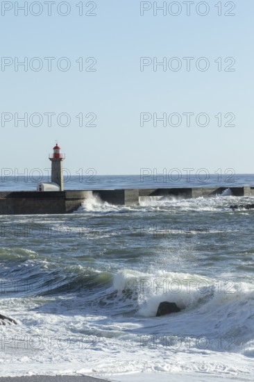 Farolim de Felgueiras lighthouse in the Atlantic Ocean and surf at Praia do Carneiro beach in Foz