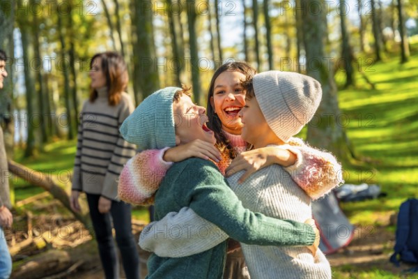 Brothers hugging enjoying camping day with family while parents talking on the background in an