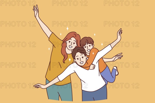 Happy family of mom, dad and child put arms to sides, pretending to be airplanes, and posing for