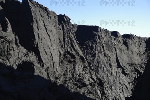 A mountain of coal dust eroded by water at a coal mine