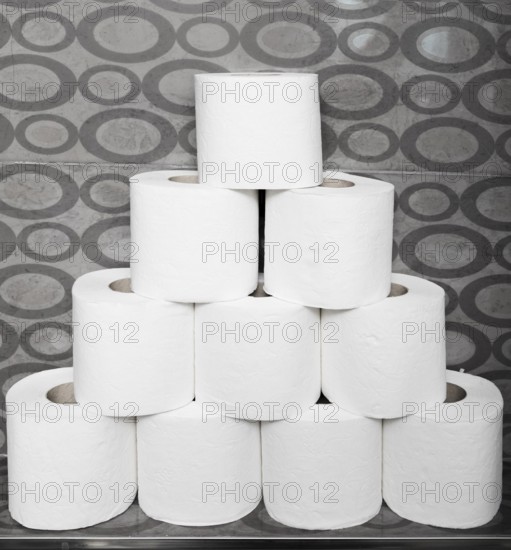 Close up stack toilet paper rolls shelf
