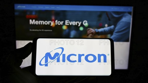 Stuttgart, Germany, 12-01-2022: Person holding cellphone with logo of American semiconductor