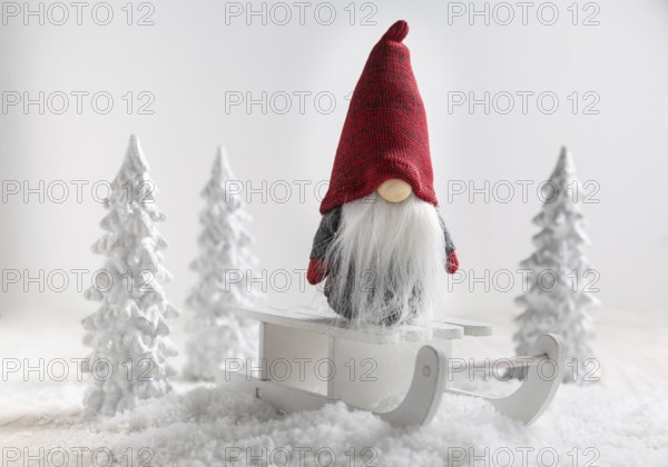 Christmas imp on sleigh with snowy landscape. Christmas decoration