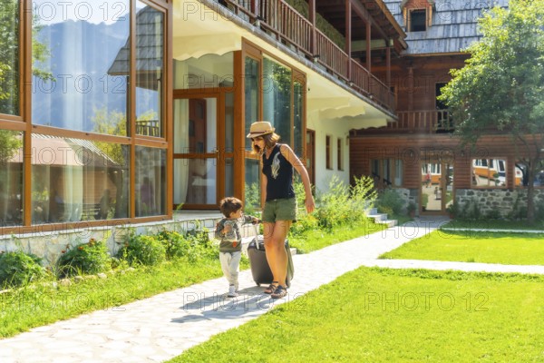Mother with her son on vacation in a cabin in the mountains, summer rural vacation in nature.