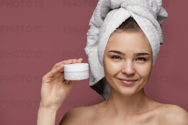 Beautiful woman using face cream
