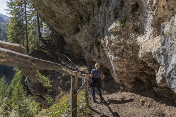 Alpine hiking trail on the rock to the Grotte' cave, vault, in Maria Alm, Salzburg