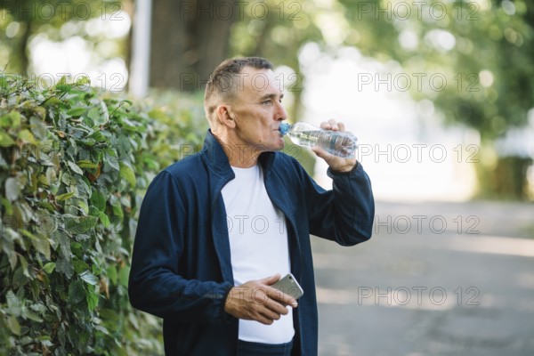 Old man drinking water park