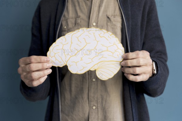 Close up man holding paper brain. Resolution and high quality beautiful photo