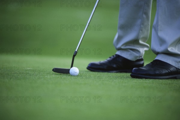 Golfer, tee off on the green, Sweden, Europe