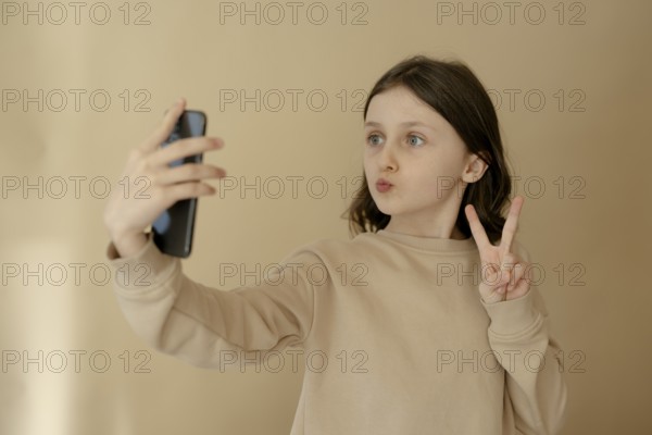 Girl, 10, takes a selfie with mobile phone