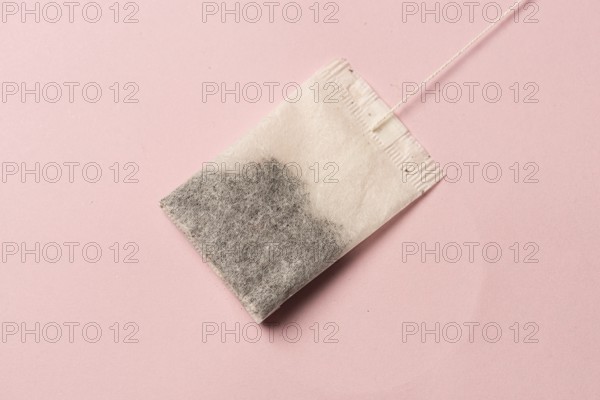 Tea bag on pink background