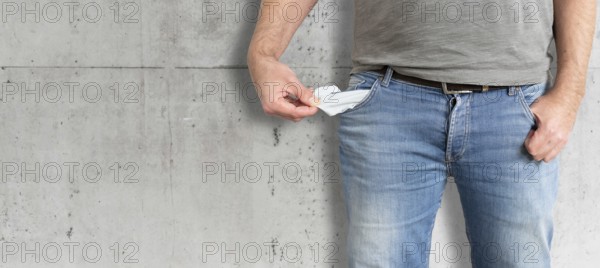 midsection of man turning his empty pockets inside out, having no money and being broke concept