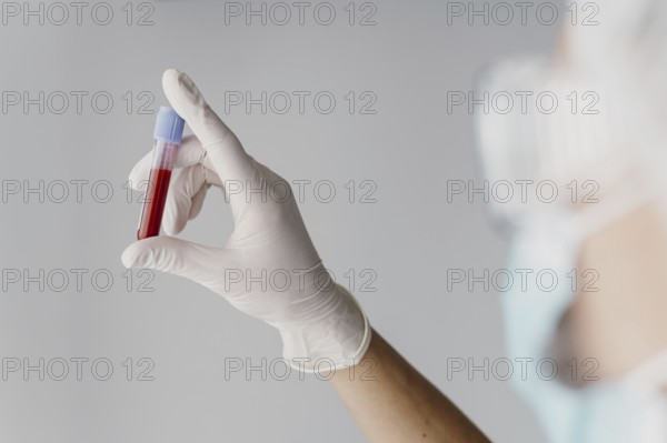 Back view doctor holding blood sample. Resolution and high quality beautiful photo