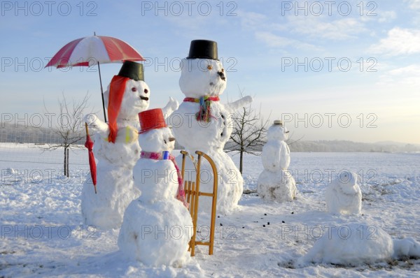 Snowman Family with animal figures, winter landscape Snowman Family with animal figures, winter