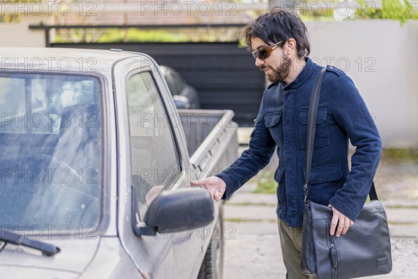 Latin businessman getting into his van