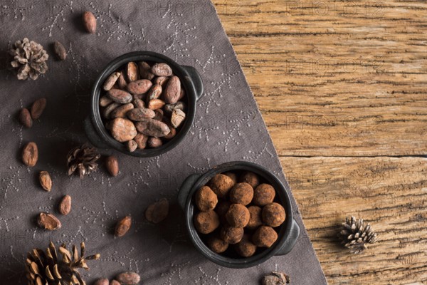 Top view cocoa beans chocolate truffles bowls