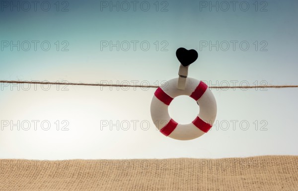 Life preserver attached to a string with heart icon