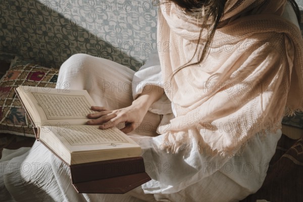 Sitting woman reading quran. Resolution and high quality beautiful photo