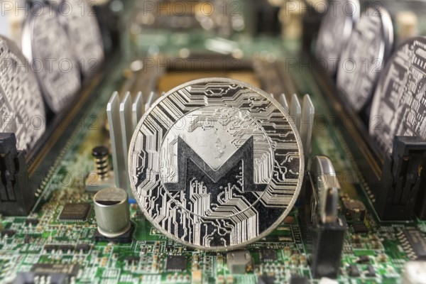 Monero coin close-up on a computer circuit motherboard as a blockchain technology payment network.