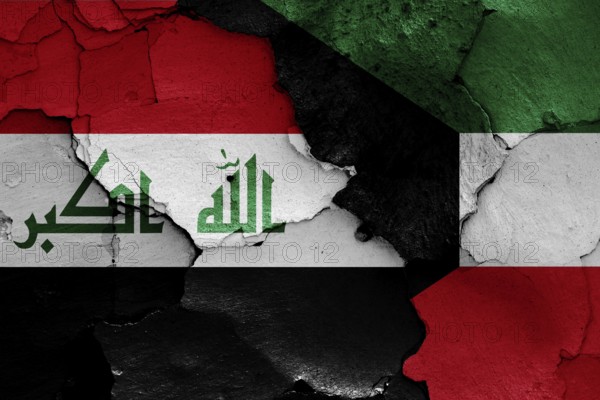 Flags of Iraq and Kuwait painted on cracked wall