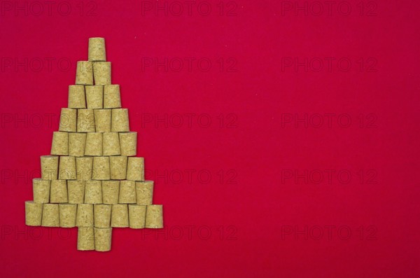 Background with christmas theme, christmas tree with wine corks on red background