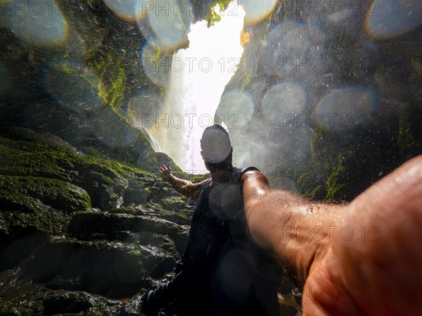 Selfie of a tourist inside the Iris grotto at the Cola de Caballo Waterfall in the Monasterio de