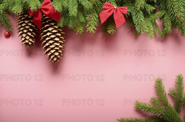 Flat lay design of Christmas greeting card of fir twigs bows and cones on pink background. Space