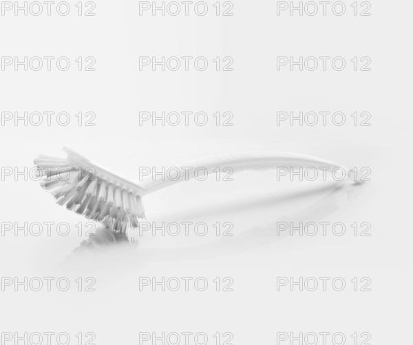 A White clean new dish brush on light grey reflective background