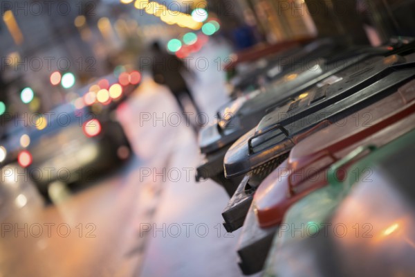 Urban street life with garbage container and street lights