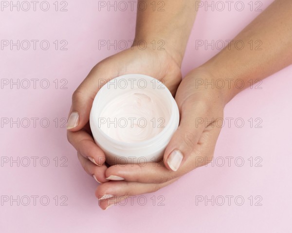 Woman holding face cream box