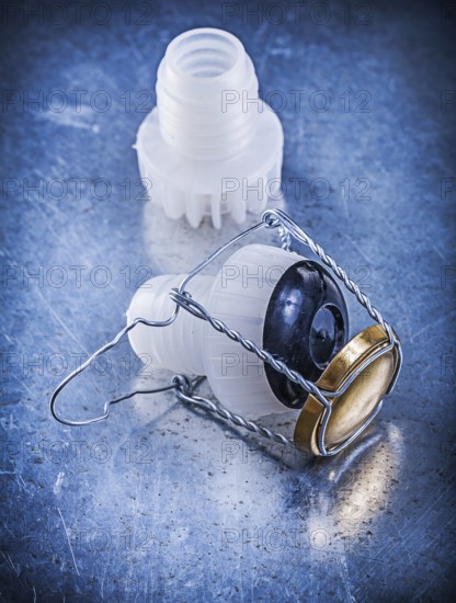 Plastic cork with twisted wire on a metallic background