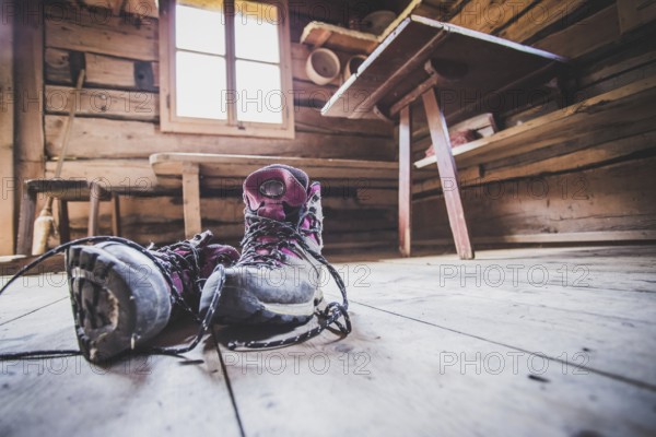 Alpine boots inside of a rustic mountain chalet, Austria, Europe