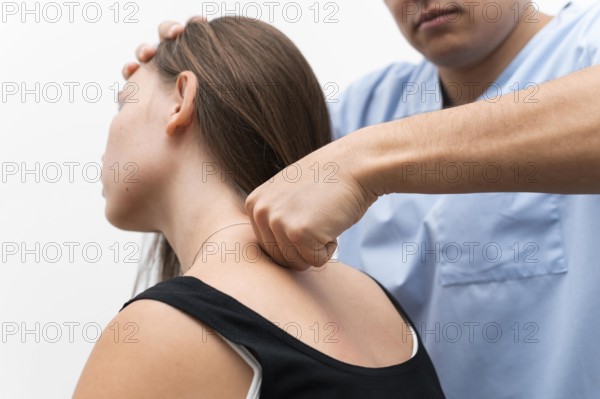 Physiotherapist massaging woman s upper back