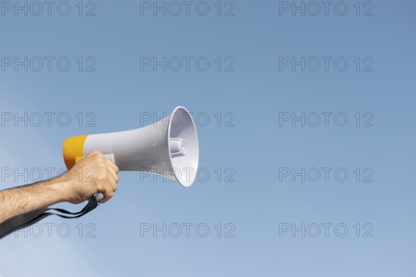 Protester holding megaphone demonstration. High resolution photo