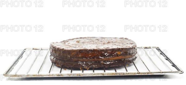 Half stage on sacher torte chocolate cake on grid before chocolate icing towards white