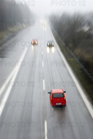 Ghost driver in red small car driving wrong direction on freeway, Autobahn near Munich, Bavaria,