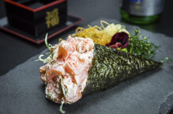 Sushi. Traditional Japanese cuisine, premium salmon Temaki with cream cheese decorated in an
