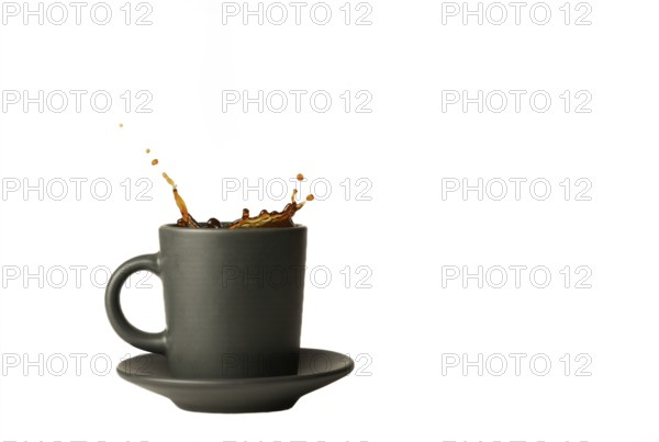 Coffee mug with splash effect splashes isolated on white background and copy space