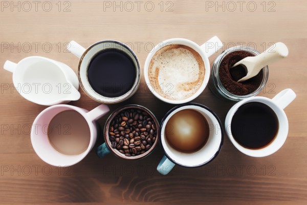 Multiple coffee cups and multicolored mugs with americano, espresso, latte and cappuccino, milk