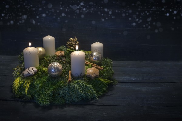 Green advent wreath with white candles, two are lit for second advent, Christmas decoration and