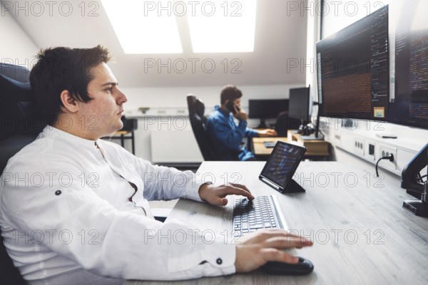 IT Programmer Working on Desktop Computer. Male Specialist Creating Innovative Software Engineer
