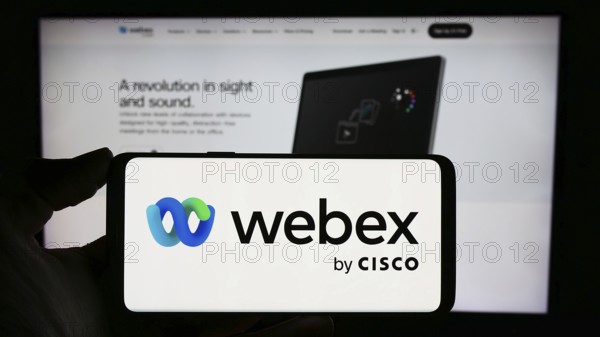 Stuttgart, Germany, 02-19-2024: Person holding mobile phone with logo of American unified