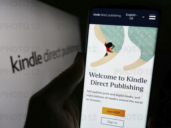 Stuttgart, Germany, 11-09-2023: Person holding mobile phone with website of Amazon e-book platform