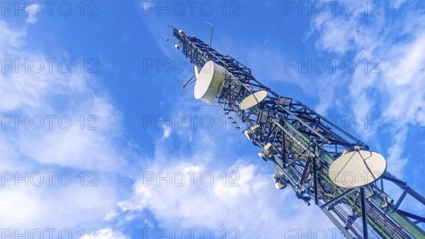 Communication tower with antennas prepared for mobile phones and internet with a blue sky in the