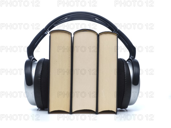 Three books with headphones, audiobooks concept on white