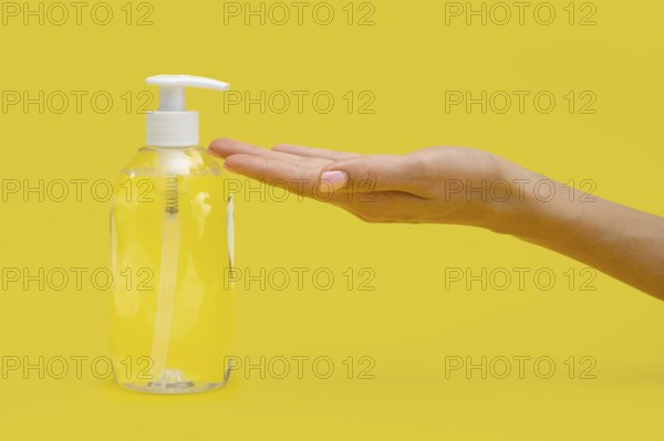 Side view hand using liquid soap