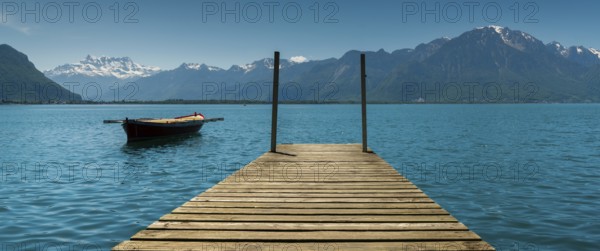 Switzerland - 31 May 2019: mountain and lake landscape with a vintage rescue rowboat and a wooden