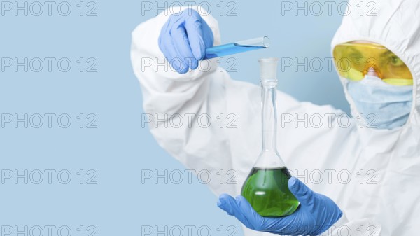 Scientist mixing chemicals with copy space